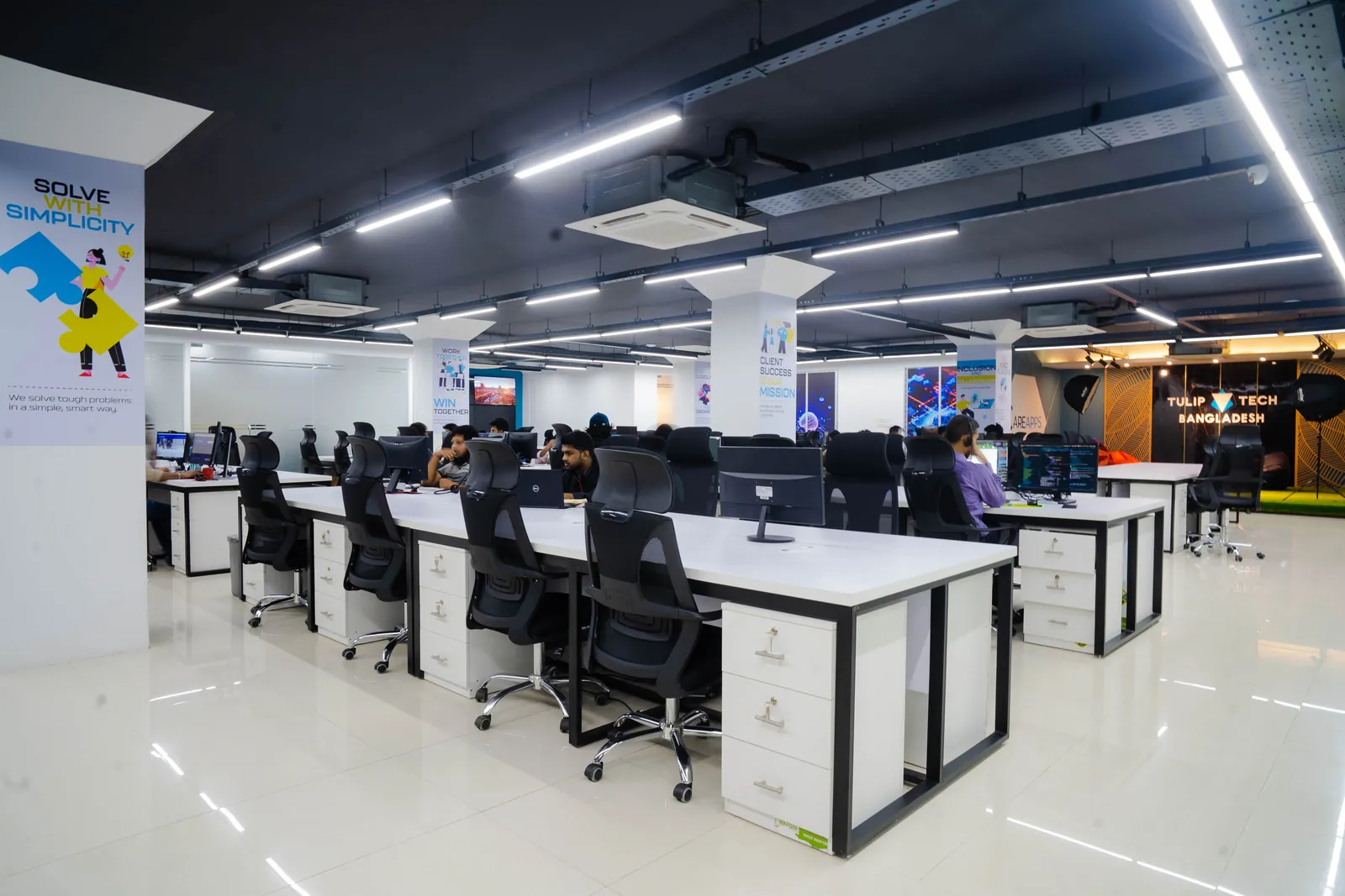 The TulipTech Dhaka engineering hub with rows of desks and branded walls