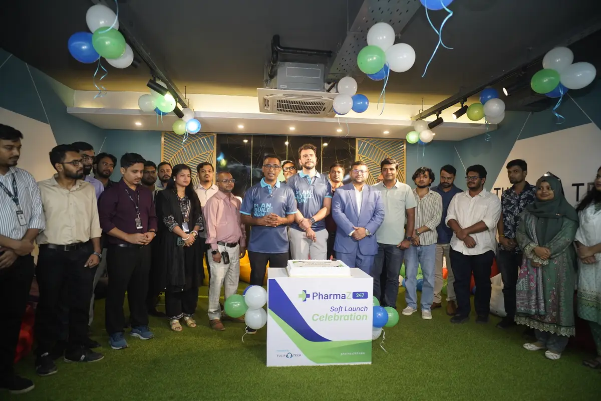 TulipTech team members and guests gathered around the PharmaZ247 soft launch celebration cake in Dhaka